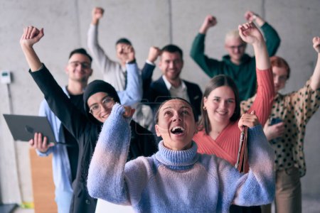 Foto de Un grupo diverso de empresarios exitosos levanta sus manos en el aire, simbolizando el logro, el logro y el cumplimiento de las metas, exudando confianza, unidad y celebración de sus - Imagen libre de derechos