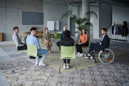 Photo for In a modern office, a diverse group of business individuals is seen gathered in a circle, engaged in lively discussions and sharing ideas about various business concepts - Royalty Free Image