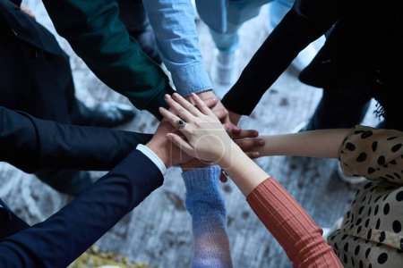 Photo for A top view photo of group of businessmen holding hands together to symbolize unity and strength. High quality photo - Royalty Free Image