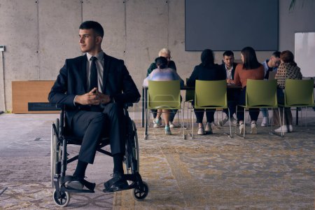 Photo for Businessman in a wheelchair commands attention, symbolizing resilience and success amidst a dynamic modern office environment - Royalty Free Image