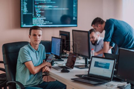 Photo for Programmers engrossed in deep collaboration, diligently working together to solve complex problems and develop innovative mobile applications with seamless functionality - Royalty Free Image