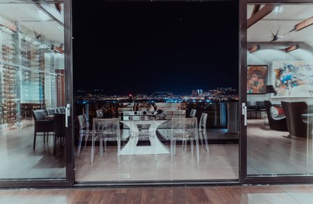 Photo for A beautiful house with a beautiful view of the night city. Luxury living room and tereasa with a view of the city. Night photo of a luxury house. High quality photo - Royalty Free Image