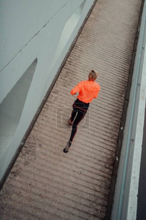Photo for Top view photo of omen in sports clothes running in a modern urban environment. The concept of a sporty and healthy lifestyle. - Royalty Free Image