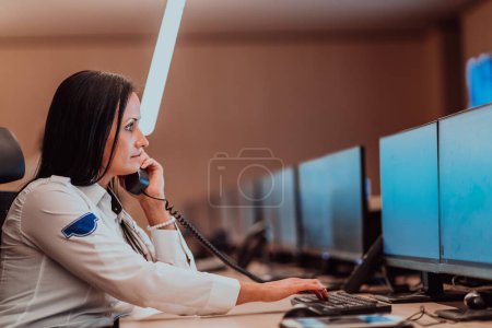 Photo for Female security operator working in a data system control room offices Technical Operator Working at workstation with multiple displays, security guard working on multiple monitors. - Royalty Free Image