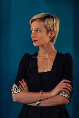 Téléchargez les photos : Blonde business woman, successful confidence with arms crossed on modern blue mat background. Selective focus. - en image libre de droit