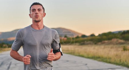 Photo for A young handsome man running in the early morning hours, driven by his commitment to health and fitness. High quality photo - Royalty Free Image