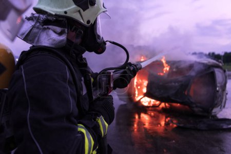 Foto de Los bomberos luchan contra la llama de fuego para controlar el fuego y no para extenderse. Concepto de bombero industrial y de seguridad pública. Tráfico o accidente de coche de rescate y ayuda a la acción - Imagen libre de derechos