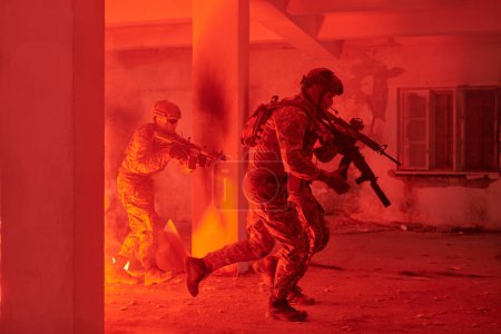Photo for A group of professional soldiers bravely executes a dangerous rescue mission, surrounded by fire in a perilous building - Royalty Free Image