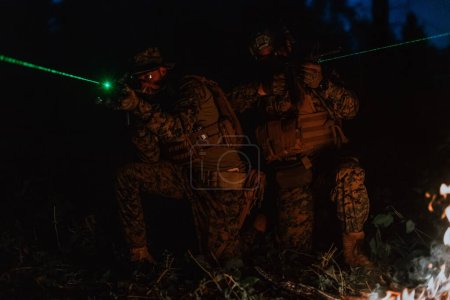 Photo for Soldiers squad in action on night mission using laser sight beam lights military team concept. - Royalty Free Image
