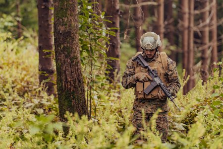 Foto de Un soldado de guerra moderno en servicio de guerra en zonas boscosas densas y peligrosas. Operaciones peligrosas de rescate militar. - Imagen libre de derechos
