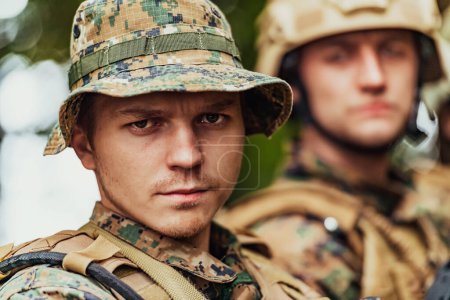 Photo for Soldier fighters standing together with guns. Group portrait of US army elite members, private military company servicemen, anti terrorist squad. - Royalty Free Image