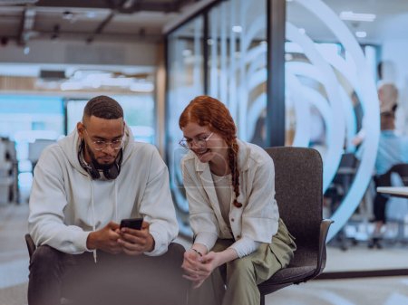 Photo for In a modern office African American young businessman and his businesswoman colleague, with her striking orange hair, engage in collaborative problem-solving sessions. - Royalty Free Image