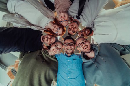 Photo for In a modern office, a group of young business professionals is captured in a warm and embracing hug, reflecting the spirit of unity, collaboration, and shared success in their dynamic workplace - Royalty Free Image