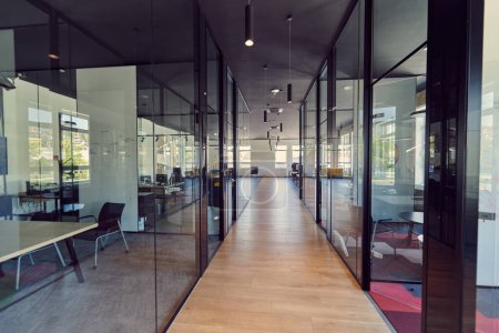 Photo for In a setting of modern, glass-walled business startup offices, the open, airy workspace reflects a contemporary and innovative ambiance, promising a dynamic environment for entrepreneurial growth. - Royalty Free Image
