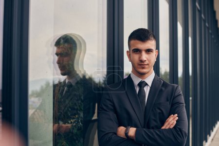 Photo for A CEO dressed in a sleek black suit stands confidently at the entrance of a modern corporate building, awaiting the start of the workday in the bustling urban environment - Royalty Free Image