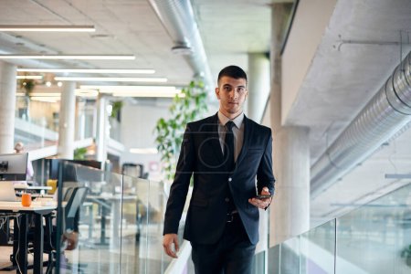 Photo for In a sleek corporate setting, the young and charismatic director strides confidently down the hallway, symbolizing his dynamic leadership and the promise of continued success within the company he - Royalty Free Image