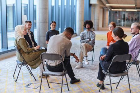 Photo for A diverse group of young business entrepreneurs gathered in a circle for a meeting, discussing corporate challenges and innovative solutions within the modern confines of a large corporation. - Royalty Free Image