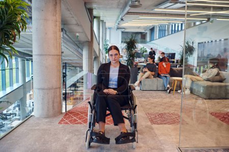 Photo for In a modern office, a young businesswoman in a wheelchair is surrounded by her supportive colleagues, embodying the spirit of inclusivity and diversity in the workplace. - Royalty Free Image