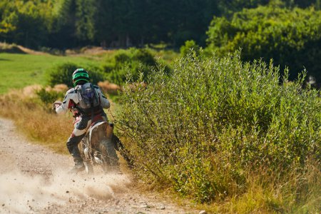 Photo for A professional motocross rider exhilaratingly riding a treacherous off-road forest trail on their motorcycle - Royalty Free Image
