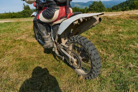 Photo for Close up photo of a professional motocross rider in action, showcasing the tire and various components of the motorcycle as they navigate the challenging off-road terrain with speed and precision - Royalty Free Image