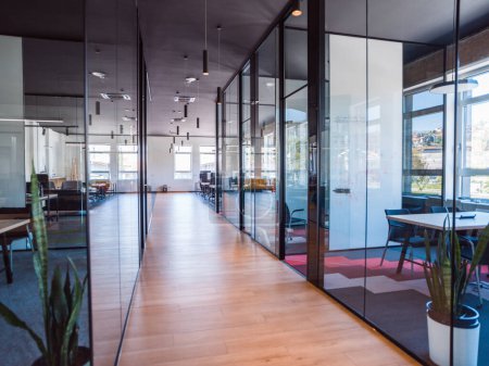Photo for In a setting of modern, glass-walled business startup offices, the open, airy workspace reflects a contemporary and innovative ambiance, promising a dynamic environment for entrepreneurial growth. - Royalty Free Image