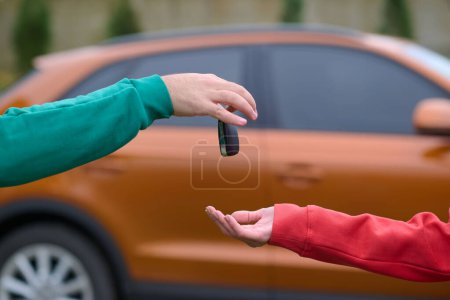 Photo for Car keys handshake, seller or car salesman and customer in a dealership, shake hands over the car keys and seal the purchase of the auto or new car. - Royalty Free Image