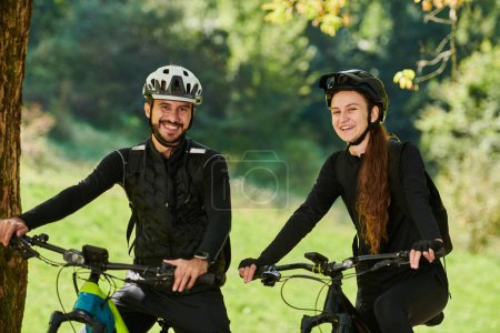 Photo for A blissful couple, adorned in professional cycling gear, enjoys a romantic bicycle ride through a park, surrounded by modern natural attractions, radiating love and happiness. - Royalty Free Image