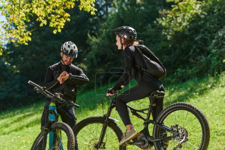 Photo for A sweet couple, equipped with bicycles and engrossed in coordinating their journey, checks their GPS mobile and watches while planning scenic routes in the park, seamlessly blending technology and - Royalty Free Image