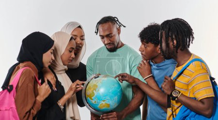 Téléchargez les photos : Un groupe diversifié d'étudiants est rassemblé autour d'un globe, absorbé dans l'exploration et l'étude, leur énergie vibrante capturée sur un fond blanc immaculé, symbolisant l'unité et la curiosité dans leur - en image libre de droit