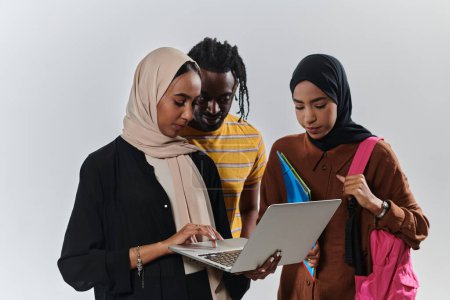 Photo for A group of students, including an African American student and two hijab-wearing women, stand united against a pristine white background, symbolizing a harmonious blend of cultures and backgrounds in - Royalty Free Image