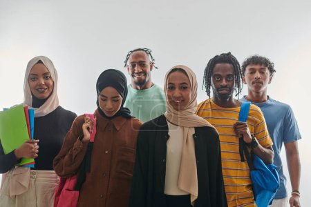 Photo for In a vibrant display of educational diversity, a group of students strikes a pose against a clean white background, holding backpacks, laptops, and tablets, symbolizing a blend of modern technology - Royalty Free Image