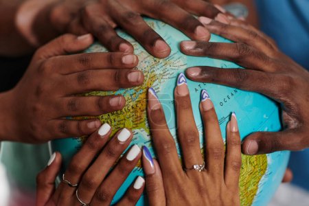 Photo for Close up of diverse teenagers hands delicately exploring a globe, capturing the essence of curiosity and exploration in their tactile engagement with geographical knowledge. - Royalty Free Image
