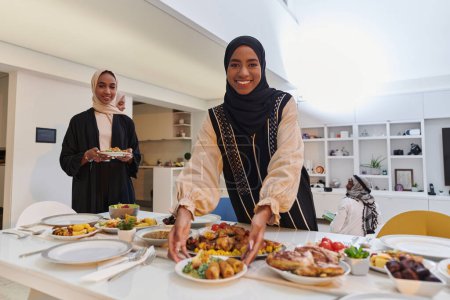 Photo for Group of young Arab women come together to lovingly prepare an iftar table during the sacred Muslim month of Ramadan, embodying the essence of communal unity, cultural tradition, and joyous - Royalty Free Image