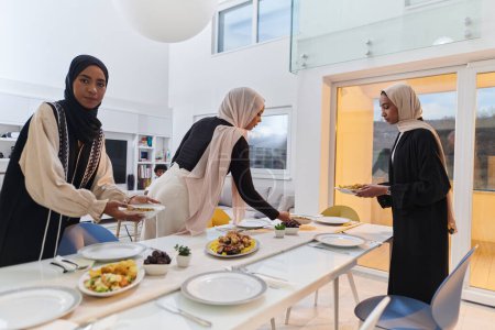 Foto de Grupo de jóvenes árabes se reúnen para preparar amorosamente una mesa de iftar durante el sagrado mes musulmán del Ramadán, encarnando la esencia de la unidad comunitaria, la tradición cultural y la alegría. - Imagen libre de derechos