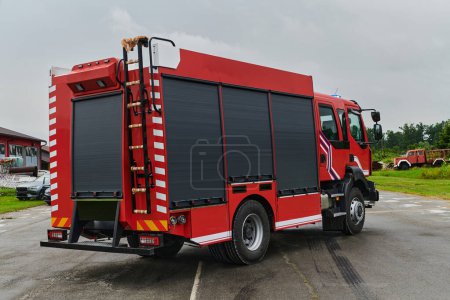 Photo for In this captivating scene, a state-of-the-art firetruck, equipped with advanced rescue technology, stands ready with its skilled firefighting team, prepared to intervene and respond rapidly to - Royalty Free Image