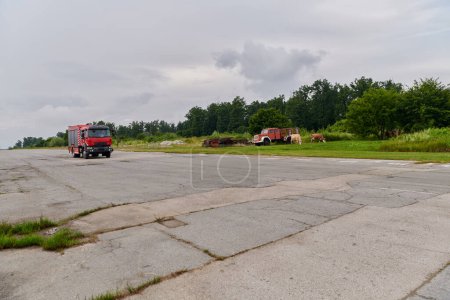 Photo for In this captivating scene, a state-of-the-art firetruck, equipped with advanced rescue technology, stands ready with its skilled firefighting team, prepared to intervene and respond rapidly to - Royalty Free Image