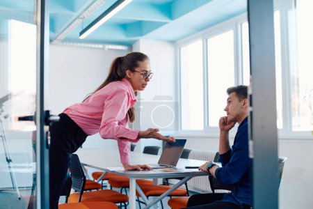 Photo for A furious business director of a startup office berating her employee for business mistakes and errors. - Royalty Free Image
