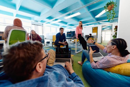 In a modern startup office, a diverse group of young and capable businesspeople engage in lively discussions about various projects, showcasing teamwork, innovation, and entrepreneurial spirit. 