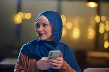 A beautiful European Muslim woman, adorned with a hijab, utilizes her smartphone to swiftly prepare for iftar during the sacred month of Ramadan, embodying the blend of tradition and modernity in her
