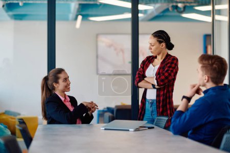 Photo for A team of successful programmers sits in a startup office, strategizing new business projects and solving existing challenges, showcasing innovation and collaboration in the tech industry. - Royalty Free Image