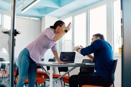 Photo for A furious business director of a startup office berating her employee for business mistakes and errors. - Royalty Free Image