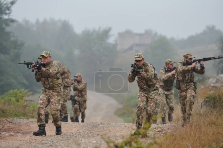 Photo for A disciplined and specialized military unit, donned in camouflage, strategically patrolling and maintaining control in a high-stakes environment, showcasing their precision, unity, and readiness for - Royalty Free Image