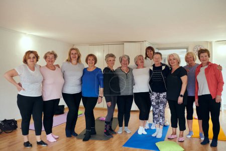 Photo for A vibrant community of senior women, guided by their instructor, embraces the enriching journey of yoga, fostering unity, well-being, and a shared commitment to active aging. - Royalty Free Image