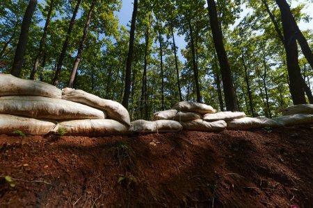 a military unit strategically employs sandbags as a defensive wall, creating a fortified barrier to enhance their safety and protection, showcasing the tactical use of simple yet effective measures