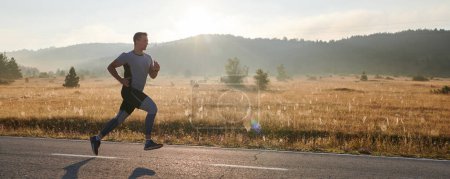 Photo for An athletic man exudes determination as he runs, embodying a commitment to a healthy lifestyle and preparation for an upcoming marathon competition - Royalty Free Image