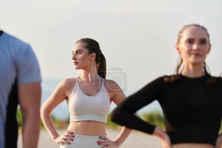 Photo for In a dynamic display of unity and preparation, a diverse group of athletes warm up together, readying themselves for a challenging running endeavor. - Royalty Free Image