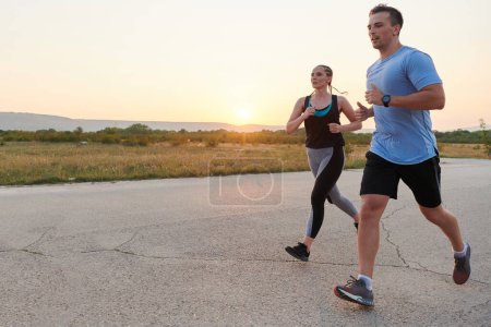 A vibrant couple dashes running the outdoors, embodying the essence of athleticism and romance, their confident strides reflecting a shared commitment to fitness and preparation for future marathon