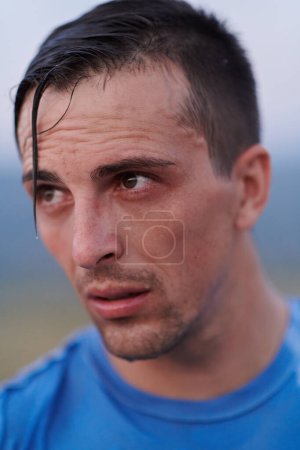 Photo for After completing a grueling daily run, a sweaty athlete takes a well-deserved rest, showcasing the physical exertion and dedication of their training regimen. - Royalty Free Image