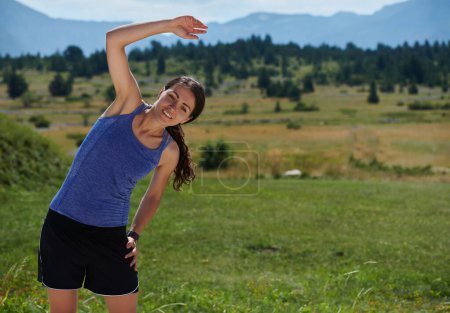 Photo for A determined athletic woman engages in post-run stretching, epitomizing dedication to her fitness journey and nurturing her bodys flexibility and well-being - Royalty Free Image