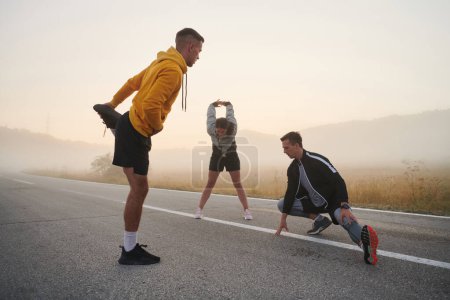 Photo for A vibrant and diverse group of athletes engage in stretching and warming up exercises, showcasing their unity and readiness for an invigorating morning run. - Royalty Free Image